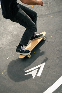 Skateboarder Rides on a Curved Path in a Skate Park