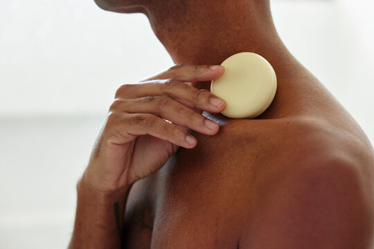 Man Using Round Body Care Product