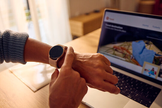Anonymous woman checks her smartwatch