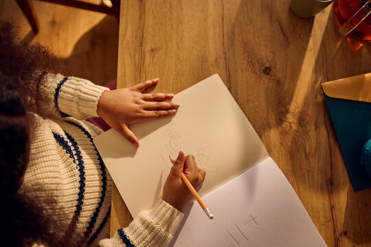 Child draws in a book