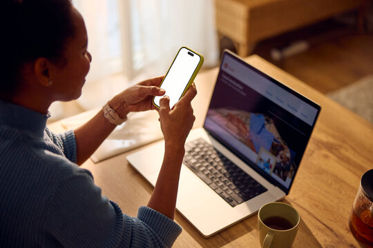 Woman works from home, using technical devices
