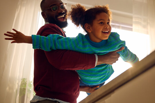 Excited father entertains his kid at home