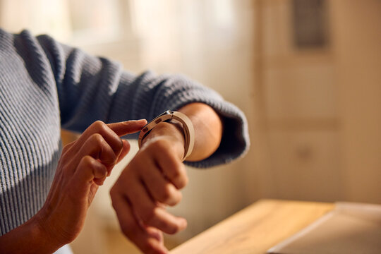 Anonymous woman checks the time