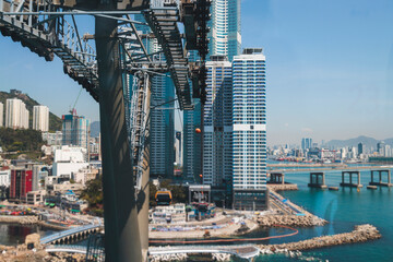 Busan Air Cruise, Busan cable car, ride on multicoloured sky capsule gondola route, with Songdo beach and Skywalk and Busan Bay panorama, South Korea, Songdo Station in a spring sunny day © tsuguliev