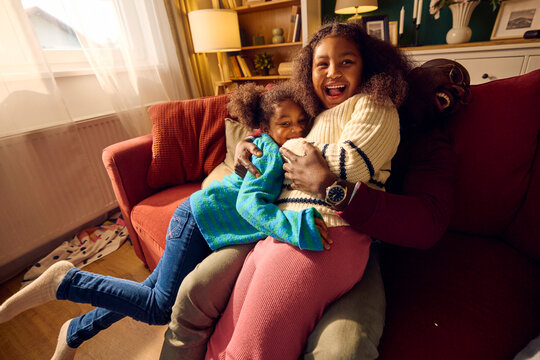 Man enjoys time with his daughters at home