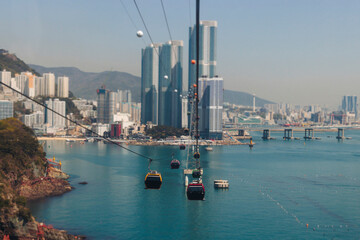 Busan Air Cruise, Busan cable car, ride on multicoloured sky capsule gondola route, with Songdo beach and Skywalk and Busan Bay panorama, South Korea, Songdo Station in a spring sunny day © tsuguliev