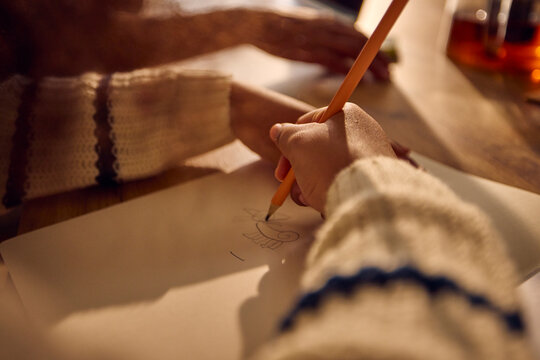 Kid draws in a notebook