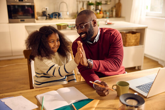 Dad assists child with homework