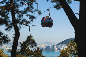 Busan Air Cruise, Busan cable car, ride on multicoloured sky capsule gondola route, with Songdo beach and Skywalk and Busan Bay panorama, South Korea, Songdo Station in a spring sunny day © tsuguliev