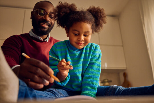 Father and daughter sktech together at home