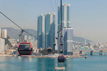 Busan Air Cruise, Busan cable car, ride on multicoloured sky capsule gondola route, with Songdo beach and Skywalk and Busan Bay panorama, South Korea, Songdo Station in a spring sunny day © tsuguliev
