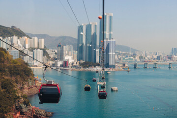 Busan Air Cruise, Busan cable car, ride on multicoloured sky capsule gondola route, with Songdo beach and Skywalk and Busan Bay panorama, South Korea, Songdo Station in a spring sunny day © tsuguliev