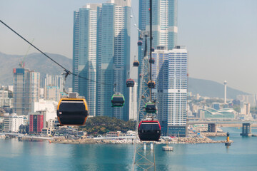 Busan Air Cruise, Busan cable car, ride on multicoloured sky capsule gondola route, with Songdo beach and Skywalk and Busan Bay panorama, South Korea, Songdo Station in a spring sunny day © tsuguliev