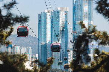 Busan Air Cruise, Busan cable car, ride on multicoloured sky capsule gondola route, with Songdo beach and Skywalk and Busan Bay panorama, South Korea, Songdo Station in a spring sunny day © tsuguliev