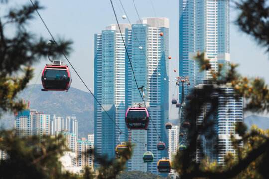 Busan Air Cruise, Busan cable car, ride on multicoloured sky capsule gondola route, with Songdo beach and Skywalk and Busan Bay panorama, South Korea, Songdo Station in a spring sunny day