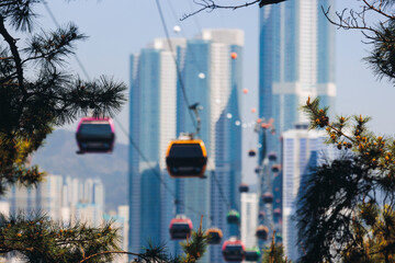 Busan Air Cruise, Busan cable car, ride on multicoloured sky capsule gondola route, with Songdo beach and Skywalk and Busan Bay panorama, South Korea, Songdo Station in a spring sunny day © tsuguliev