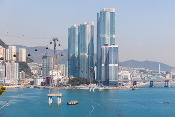 Busan Air Cruise, Busan cable car, ride on multicoloured sky capsule gondola route, with Songdo beach and Skywalk and Busan Bay panorama, South Korea, Songdo Station in a spring sunny day © tsuguliev