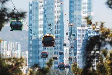 Busan Air Cruise, Busan cable car, ride on multicoloured sky capsule gondola route, with Songdo beach and Skywalk and Busan Bay panorama, South Korea, Songdo Station in a spring sunny day © tsuguliev
