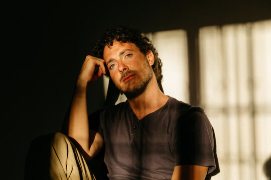 Man with curly hair during golden hour