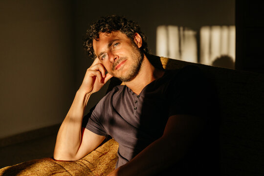 Man smiling resting on couch