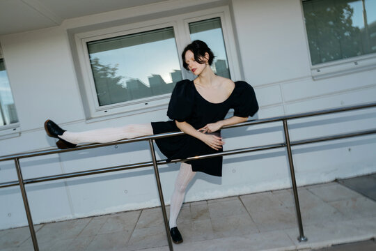 Blurry woman in black dress and white tights