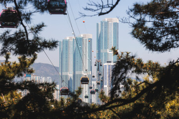 Busan Air Cruise, Busan cable car, ride on multicoloured sky capsule gondola route, with Songdo beach and Skywalk and Busan Bay panorama, South Korea, Songdo Station in a spring sunny day © tsuguliev