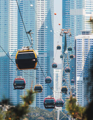 Busan Air Cruise, Busan cable car, ride on multicoloured sky capsule gondola route, with Songdo beach and Skywalk and Busan Bay panorama, South Korea, Songdo Station in a spring sunny day © tsuguliev
