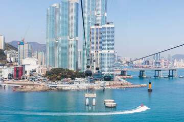 Busan Air Cruise, Busan cable car, ride on multicoloured sky capsule gondola route, with Songdo beach and Skywalk and Busan Bay panorama, South Korea, Songdo Station in a spring sunny day © tsuguliev
