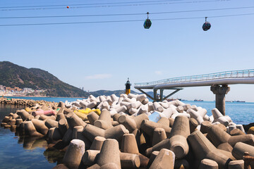 Busan Air Cruise, Busan cable car, ride on multicoloured sky capsule gondola route, with Songdo beach and Skywalk and Busan Bay panorama, South Korea, Songdo Station in a spring sunny day © tsuguliev