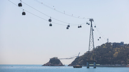 Busan Air Cruise, Busan cable car, ride on multicoloured sky capsule gondola route, with Songdo beach and Skywalk and Busan Bay panorama, South Korea, Songdo Station in a spring sunny day © tsuguliev