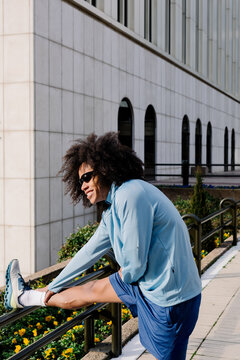 A runner performs leg stretching exercises to improve flexibility