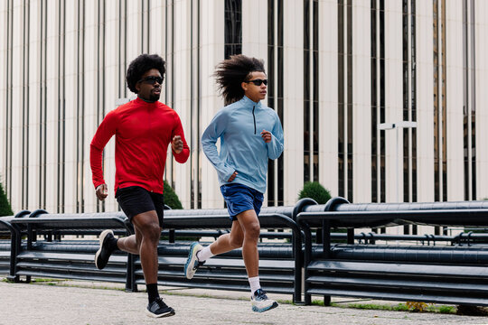 Athletic men maintaining an active lifestyle amid sleek office towers