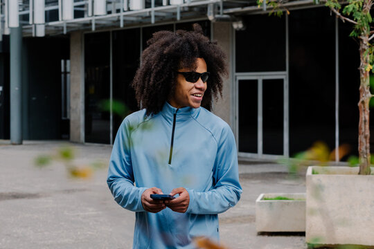 Athletic man using his smartphone to check his physical performance