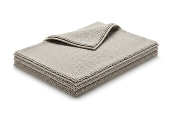 Stack of soft beige towels with decorative trim on white background