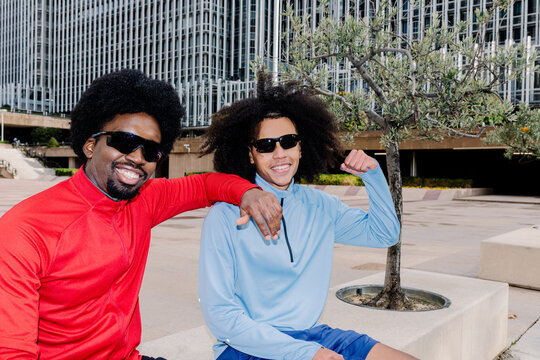 Mid-range portrait lit by flash of sportsmen smiling at the camera