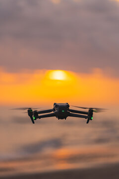 Drone flying at sunset over the ocean