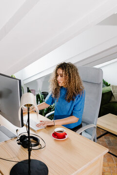 Self-employed woman seated at her home office desk