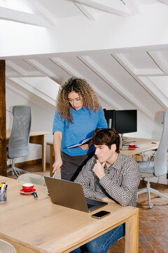 Self-employed person attentively listening to feedback from a coworker
