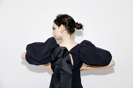 Woman wearing black puff sleeve dress 
