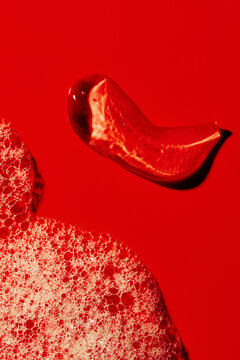Close-up View of Red Liquid and Bubbles on Flat Surface