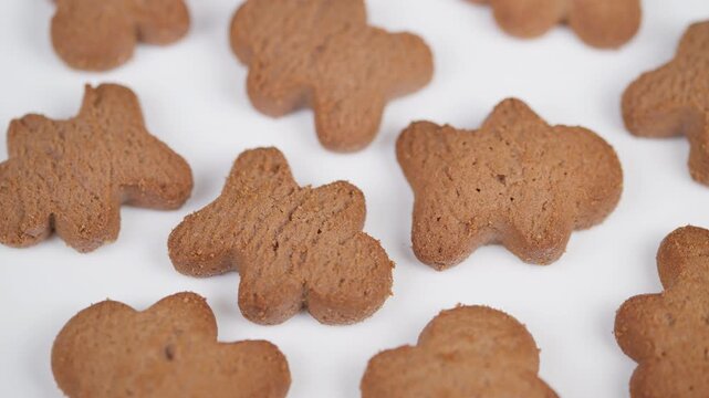 Gingerbread cookies display. Sweet cookies captured with warm studio lighting. Artistic arrangement of cinnamonspeckled gingerbread cookies under bright studio illumination