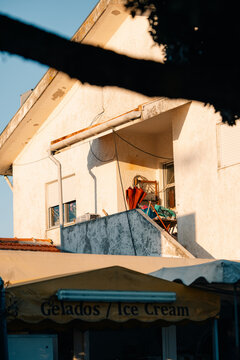 Sunlight Hits Balcony of a Building in a Busy Street in Summer