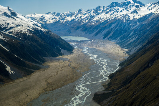 Valley with braided river leading to a glacial lake. 
