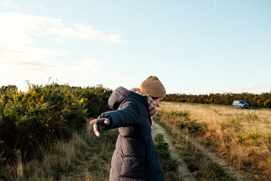 Woman Walking on Rural Path in Winter