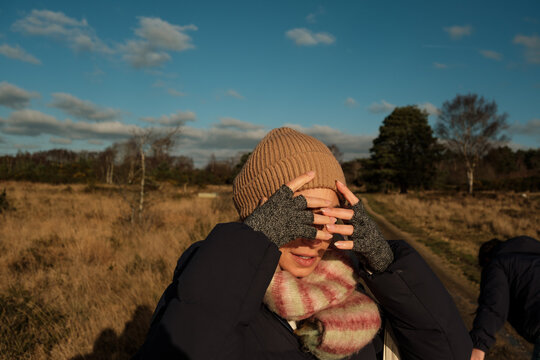 Woman Shielding Eyes in Winter Sun