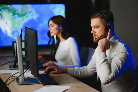 Dispatch center operators monitoring logistics and transportation at night