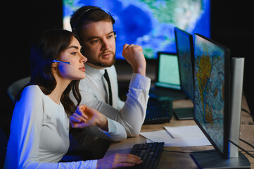 Air traffic controllers managing flight operations at night © Serhii