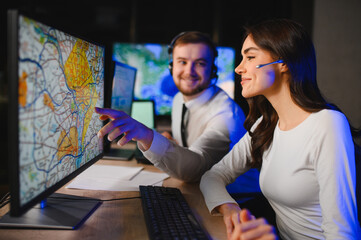 Call center operators tracking logistics on computer map