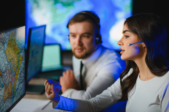 Dispatch center operators tracking freight logistics on screens