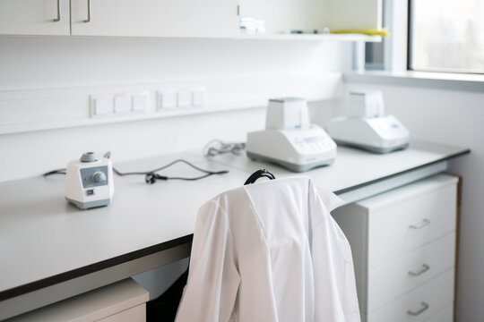 Laboratory Workspace With Equipment and Lab Coat Hanging